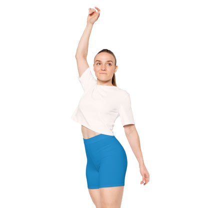 A person is shown from the side, wearing bright blue Pansexual Pride Flag Bike Shorts, which feature three vertical stripes in blue, yellow, and pink on the side - the pan pride flag. The high-waisted, moisture-wicking active wear showcases a light skin tone against a plain white background.