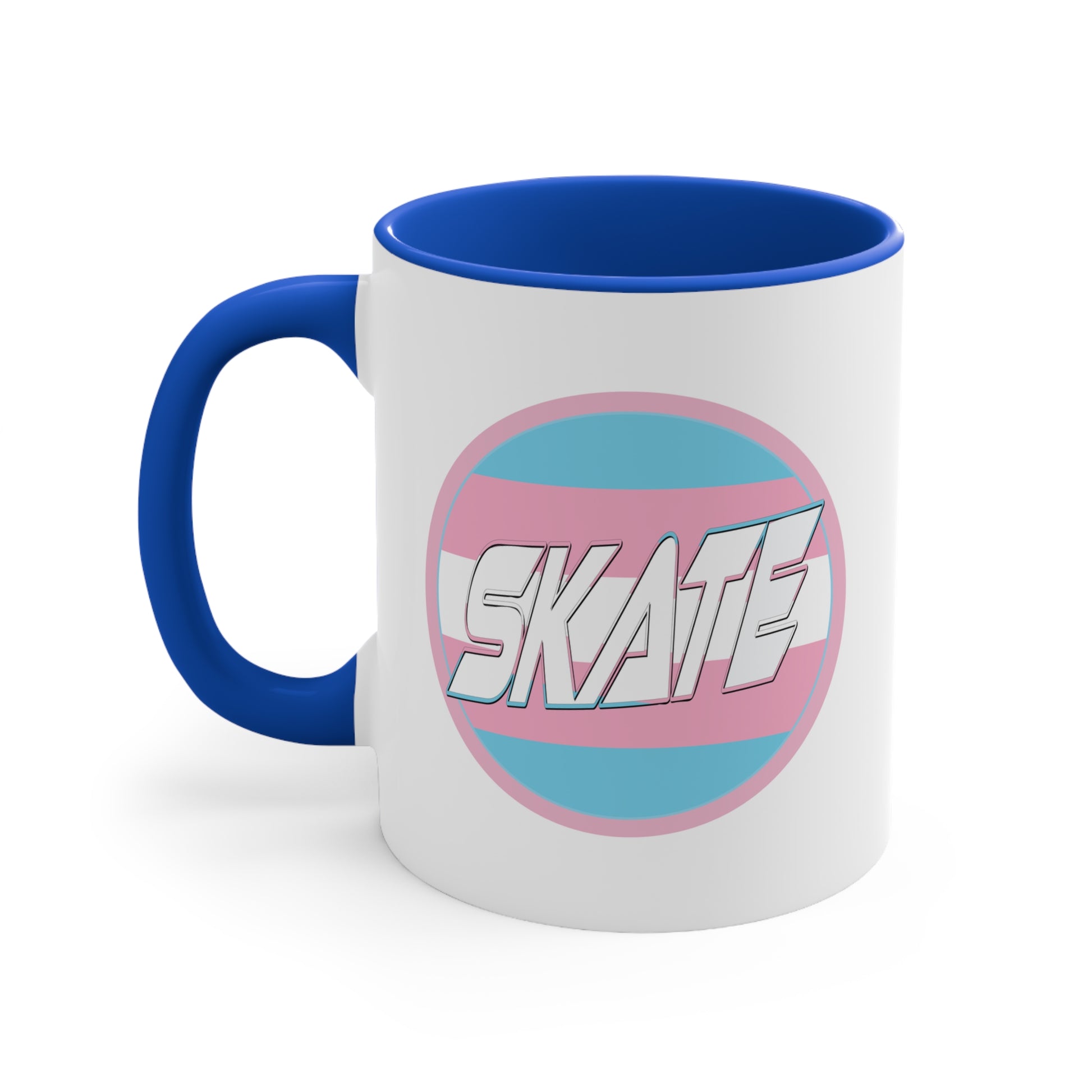 The SKATE trans flag circle design accent mug by Printify features a white exterior, blue handle, and blue interior. It showcases a circular design inspired by the trans flag, incorporating pink, light blue, and white colors. The word "SKATE" is prominently displayed in dynamic white letters at the center of the design.