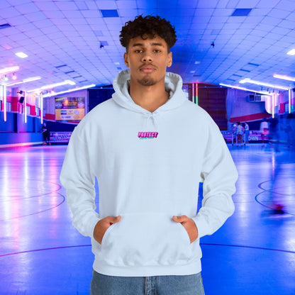 A person in a white "Protect Trans Kids" hoodie, made of ethically grown cotton, stands at the center of a neon-lit roller rink. Blurred skaters circle around as blue and pink lights illuminate the scene. The unisex heavy blend sweatshirt showcases a small "Protect" logo on the chest.