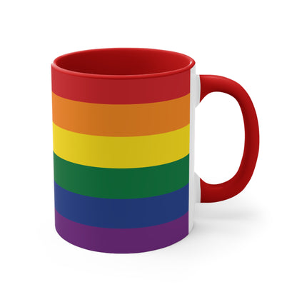 The Rainbow Pride Flag Colorful Accent Mug by Printify is a white ceramic mug featuring a red handle and interior. The exterior showcases horizontal stripes in the vibrant colors of the LGBTQ+ pride flag—red, orange, yellow, green, blue, and purple—offering a striking color contrast.