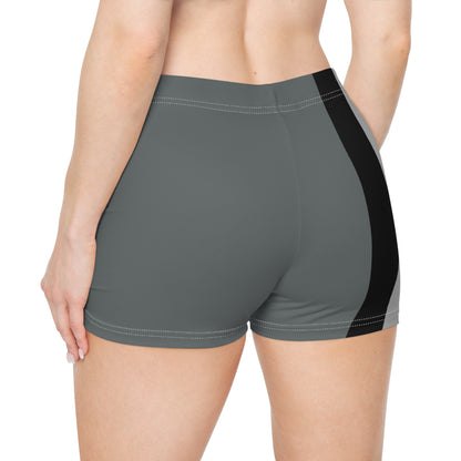 A person is shown from the side wearing Gay Skate's Aromantic Pride Flag Short Shorts, featuring vertical stripes in black, grey, white, green, and dark green. The unisex activewear shorts fit snugly. A great look for festivals, clubbing, roller derby or the gym.