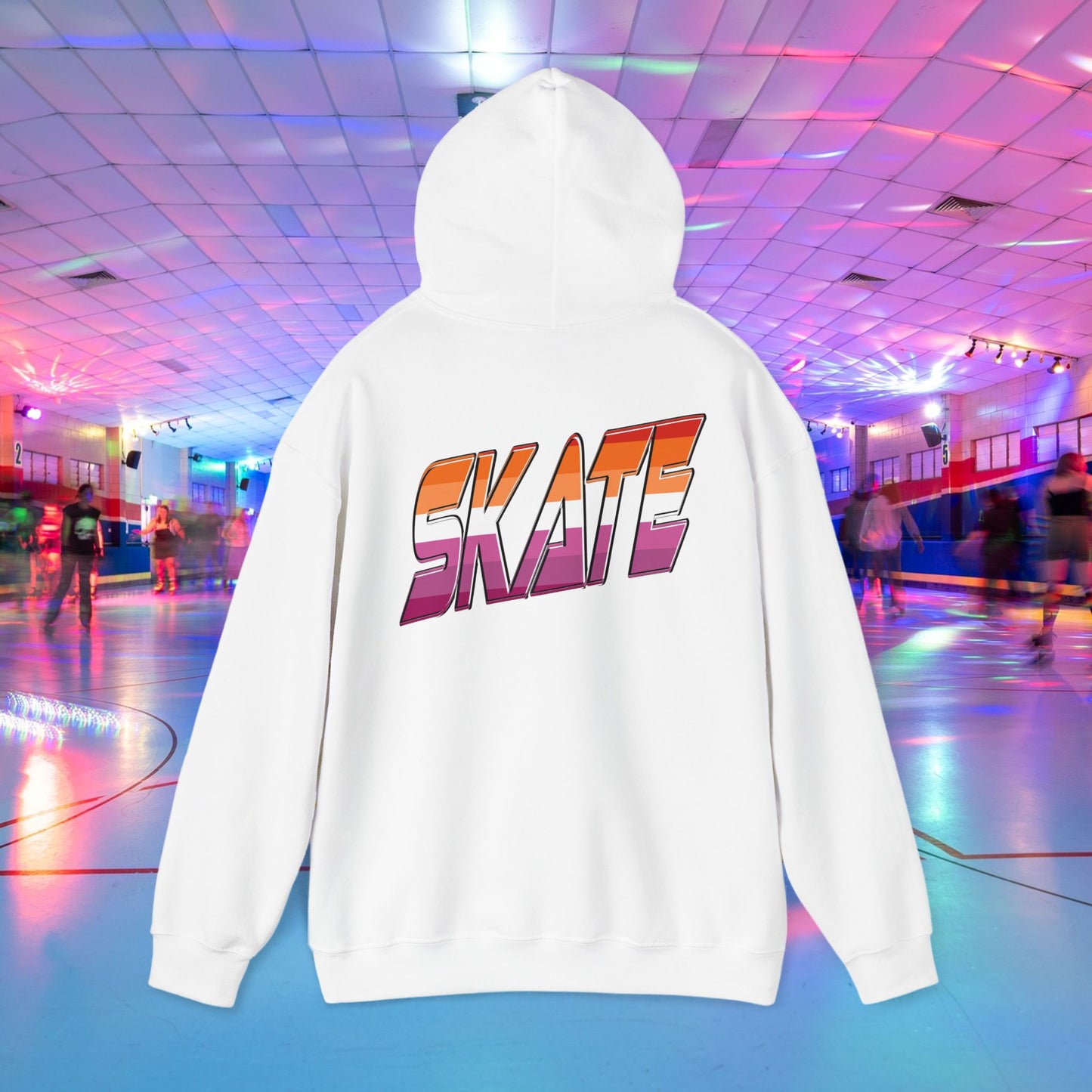 A black unisex "SKATE Lesbian Hoodie" by Printify, crafted from ethically grown US cotton, features the word "SKATE" in bold, colorful letters on the back. The hoodie is showcased in the foreground of a vibrant roller skating rink with neon lights and people skating in the background. Available for shipping to Australia.