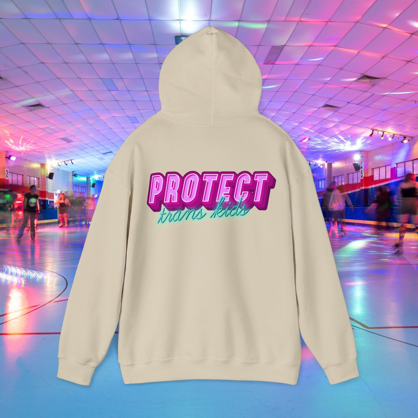 The "Protect Trans Kids" hoodie, available for Australian shipping, features a beige unisex heavy blend with vibrant pink and teal text. The ethically grown cotton backdrop displays a lively indoor roller skating rink scene with skaters and neon lights.