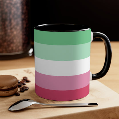 The Abro, Abroromantic, Abrosexual pride flag Accent Mug by Printify is a ceramic mug designed with horizontal stripes in green, light green, white, pink, and red to reflect the vibrant hues of the Abrosexual pride flag. It also features a pink handle and a colorful interior.