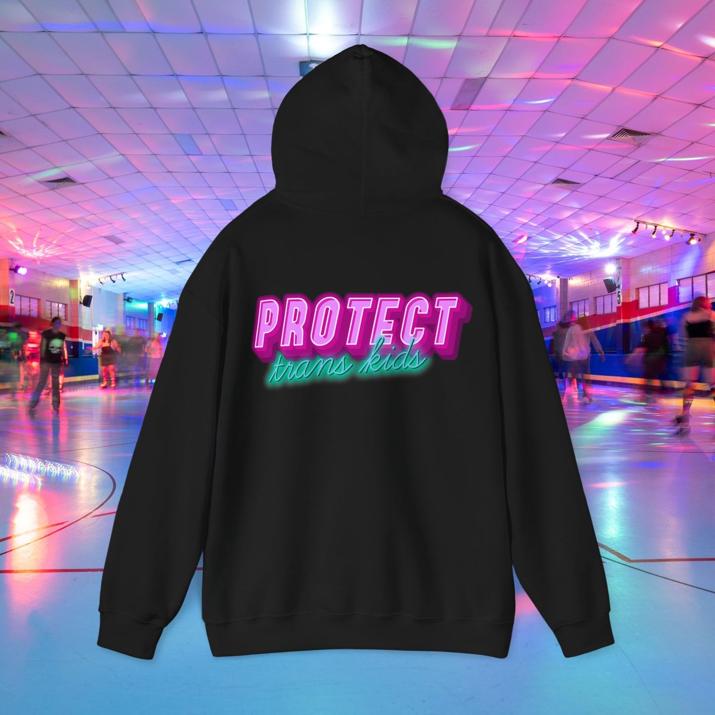 The Protect Trans Kids Hoodie - Australian Shipping is a black, unisex hoodie made from ethically grown cotton, adorned with "PROTECT trans kids" in neon pink and green. Its vibrant design pops against a colorful, illuminated skating rink filled with skaters.