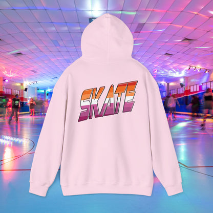 A black unisex "SKATE Lesbian Hoodie" by Printify, crafted from ethically grown US cotton, features the word "SKATE" in bold, colorful letters on the back. The hoodie is showcased in the foreground of a vibrant roller skating rink with neon lights and people skating in the background. Available for shipping to Australia.