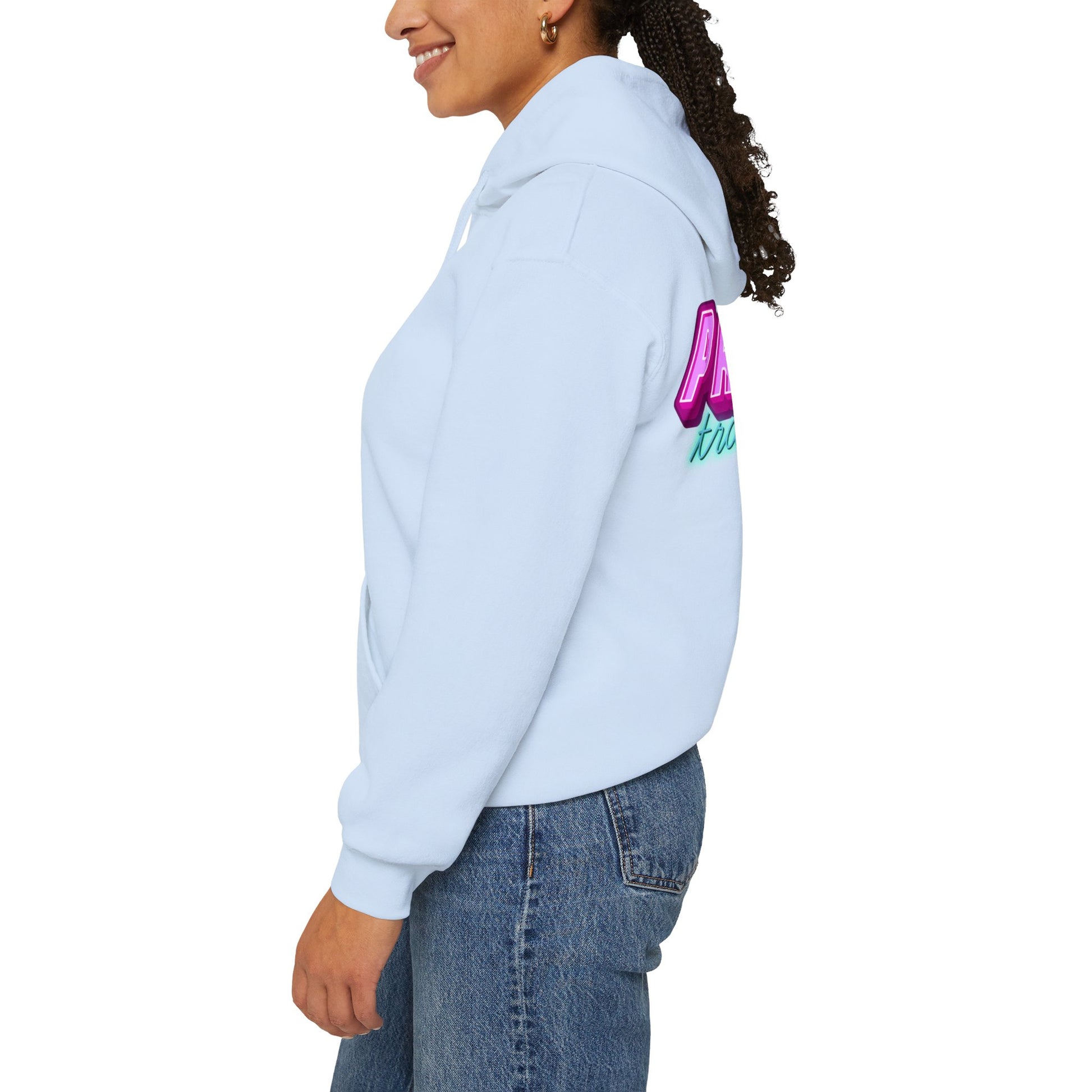 A person wearing the Protect Trans Kids Hoodie in light blue, made from ethically grown cotton and featuring a vibrant sleeve design, smiles while standing sideways in jeans against a plain white background.