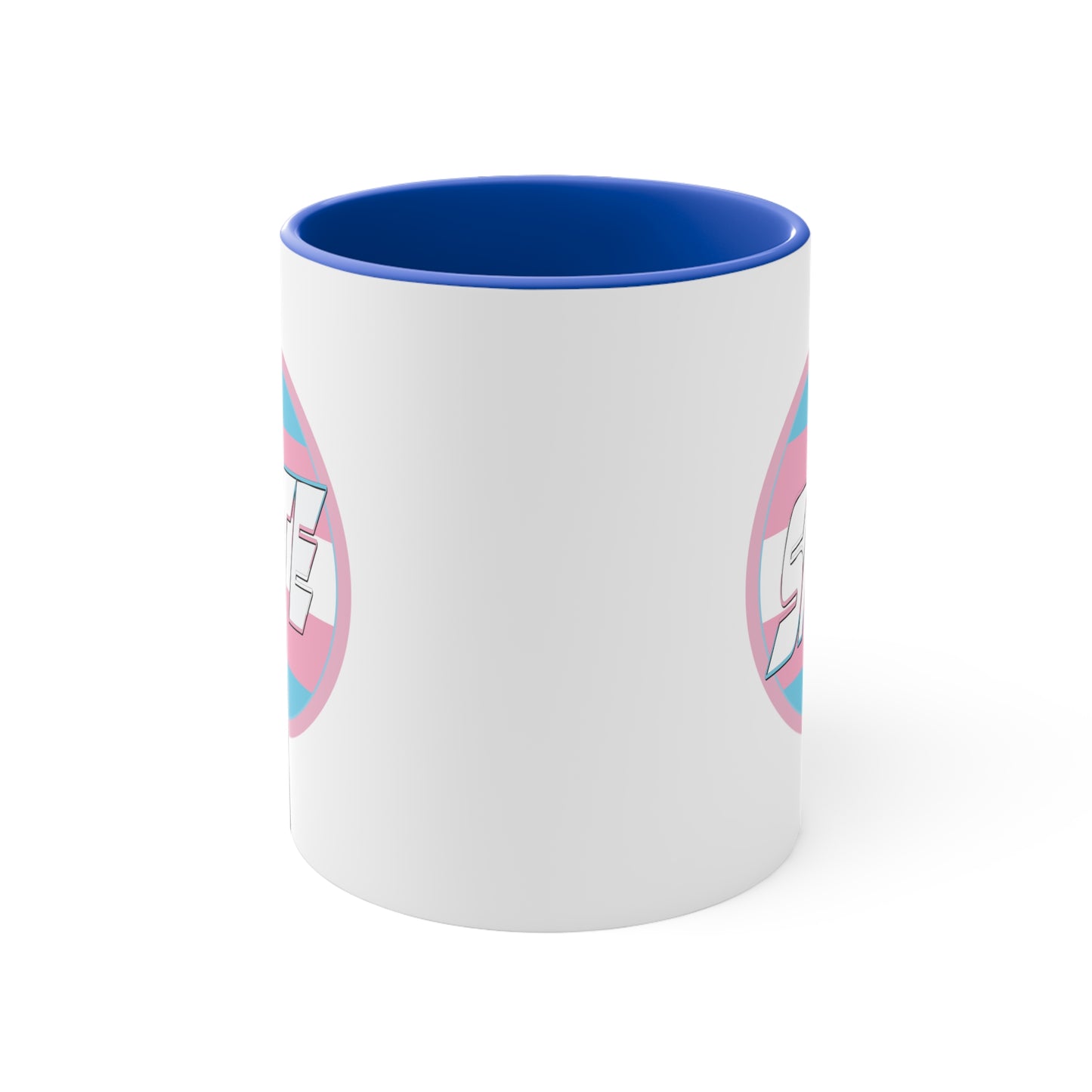 The SKATE trans flag circle design accent mug by Printify features a white exterior, blue handle, and blue interior. It showcases a circular design inspired by the trans flag, incorporating pink, light blue, and white colors. The word "SKATE" is prominently displayed in dynamic white letters at the center of the design.