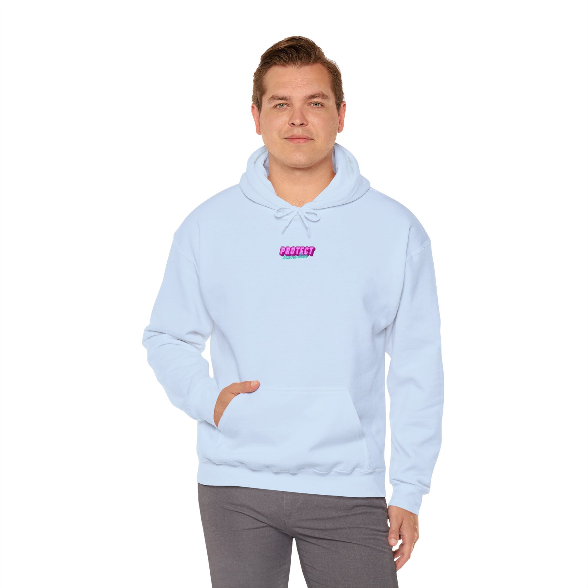 A person is wearing the "Protect Trans Kids Hoodie - Australian Shipping," a light blue unisex heavy blend sweatshirt featuring a small pink and purple text design. They have one hand in the pocket while standing against a plain white background.