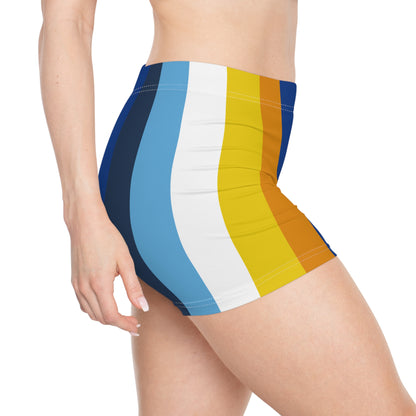 A person is wearing the Aroace Aromantic-Asexual Pride Flag Short Shorts by Printify, featuring colorful, moisture-wicking active wear in high-waisted shorts with vertical stripes in shades of blue, white, yellow, and orange. The background is plain white, and the image focuses on the side of the body from the chest down to mid-thigh.