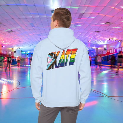 A person with short hair is wearing a GAYSKATE SKATE Progress Pride Hoodie, showcasing a rainbow pride flag gradient "SKATE" design on the back. They are facing away from the camera in a roller skating rink illuminated by vibrant, colorful lights and surrounded by other skaters.