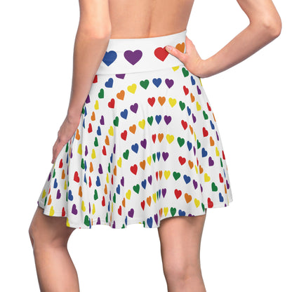 Introducing the Rainbow Pride Hearts Skater Skirt by Gay Skate: a white pleated skater skirt adorned with a pattern of colorful pride flag rainbow hearts in various sizes. The hearts come in vibrant shades of red, orange, yellow, green, blue, and purple. Featuring a cozy soft touch and a waistband highlighted with purple hearts, this versatile piece is sure to become an everyday favorite.