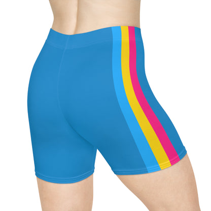 A person is shown from the side, wearing bright blue Pansexual Pride Flag Bike Shorts, which feature three vertical stripes in blue, yellow, and pink on the side - the pan pride flag. The high-waisted, moisture-wicking active wear showcases a light skin tone against a plain white background.