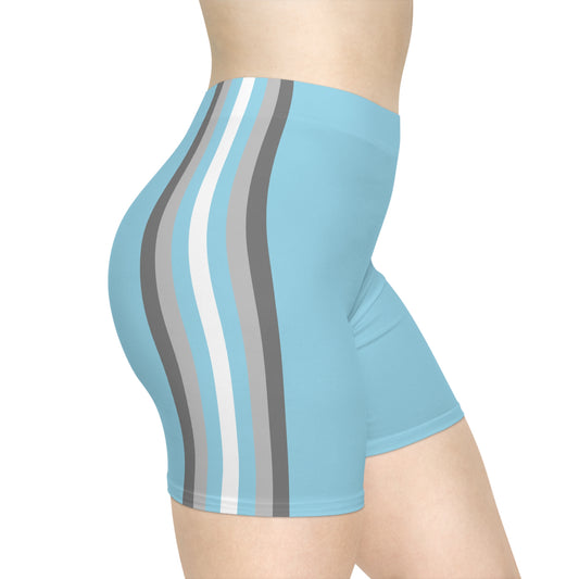 A person is wearing Demiboy Pride Flag Bike Shorts by Printify, made from moisture-wicking polyester in light blue, showcasing vertical stripes in white, light gray, and dark gray on the side. The photo captures them from a side angle against a plain background.