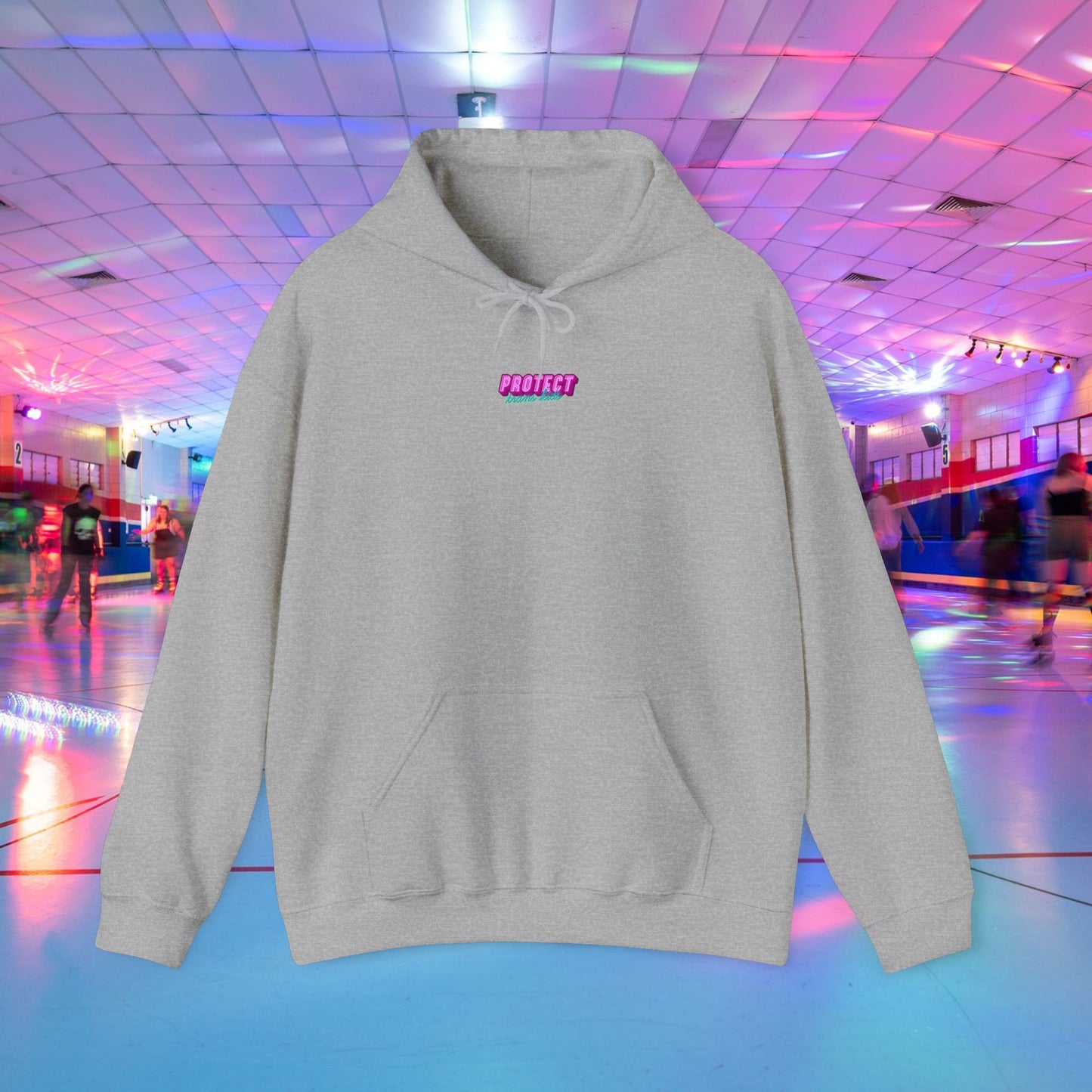 The "Protect Trans Kids Hoodie - Australian Shipping" is a unisex gray hoodie with "PROTECT" in pink on the front. Made from ethically grown cotton, it's perfect for adventurous skaters gliding under vibrant blue, pink, and purple lights at a colorful roller rink.