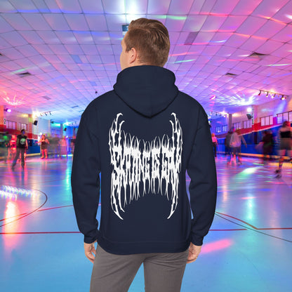 A person wearing the "SKATING IS GAY but make it death metal" hoodie stands in a brightly lit roller skating rink. The rink is adorned with colorful lights, and other people are skating in the background.