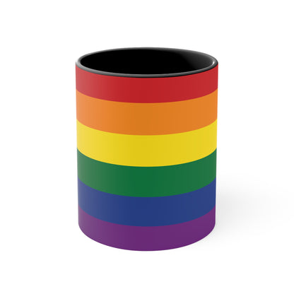 The Rainbow Pride Flag Colorful Accent Mug by Printify is a white ceramic mug featuring a red handle and interior. The exterior showcases horizontal stripes in the vibrant colors of the LGBTQ+ pride flag—red, orange, yellow, green, blue, and purple—offering a striking color contrast.