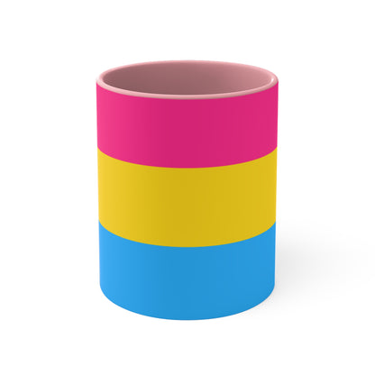 The Pansexual Pride Flag colourful accent mug from Printify features a ceramic design with a pink handle and colorful interior that showcases the colors of the pan pride flag: pink on top, yellow in the middle, and blue on the bottom.