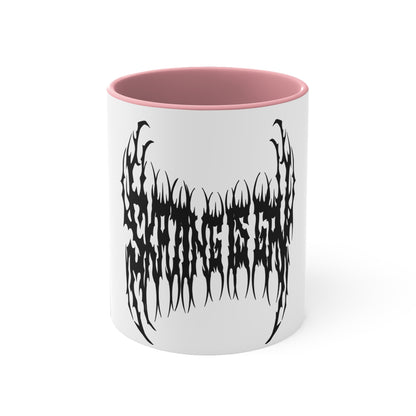 The "SKATING IS GAY but make it death metal accent mug" by Printify is a white mug with a black interior featuring an intricate design that resembles sharp, thorny text. Styled in a death metal font, the symmetrical design has an aggressive, edgy appearance that makes the text difficult to read due to its complex, spiky style.