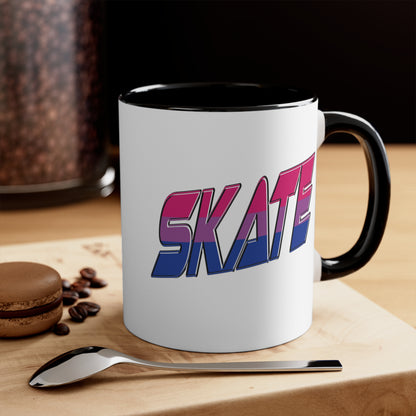 The Printify SKATE bisexual pride flag accent mug features a white base with a blue handle and vibrant interior. It proudly displays the word "SKATE" in bold, stylized gradient lettering, transitioning from pink at the top to blue at the bottom, creating an eye-catching contrast that evokes a sense of movement and energy.