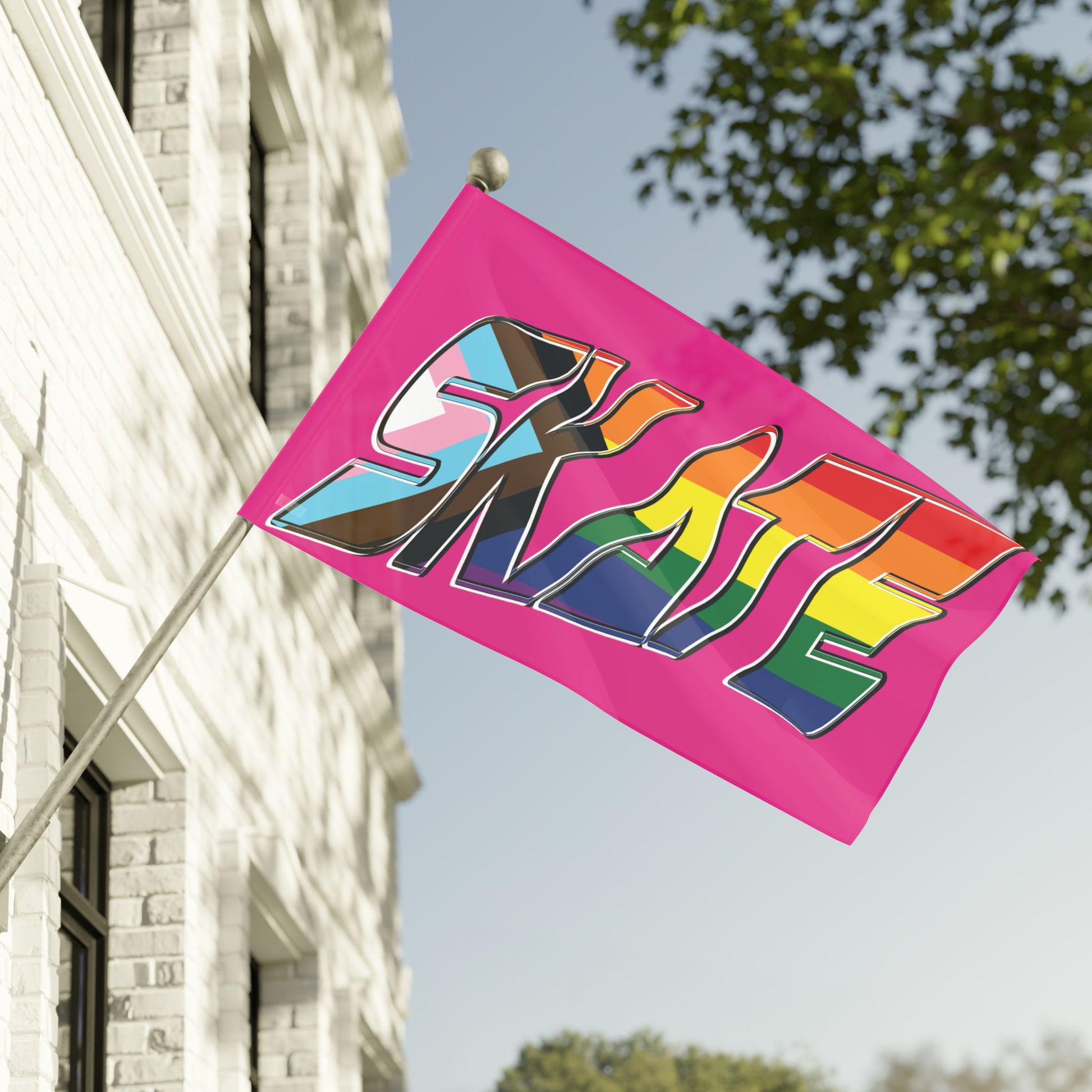 Gay Skate's SKATE progress pride original logo flag - on pink features a bold graphic with the multicolored rainbow pride word "SKATE" on a vibrant pink background. The letters are adorned in the colors of both the rainbow flag and the transgender pride flag, celebrating inclusivity and queer skating pride within the community.