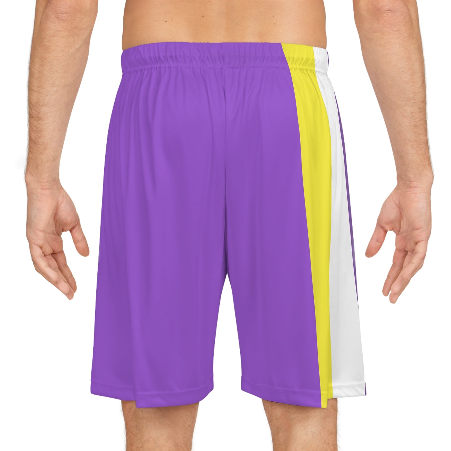 A person wearing Printify's Non-Binary Pride Flag Basketball Shorts in purple, which feature a multicolored side panel with vertical stripes of white, yellow, black, and purple, along with an adjustable waistband.