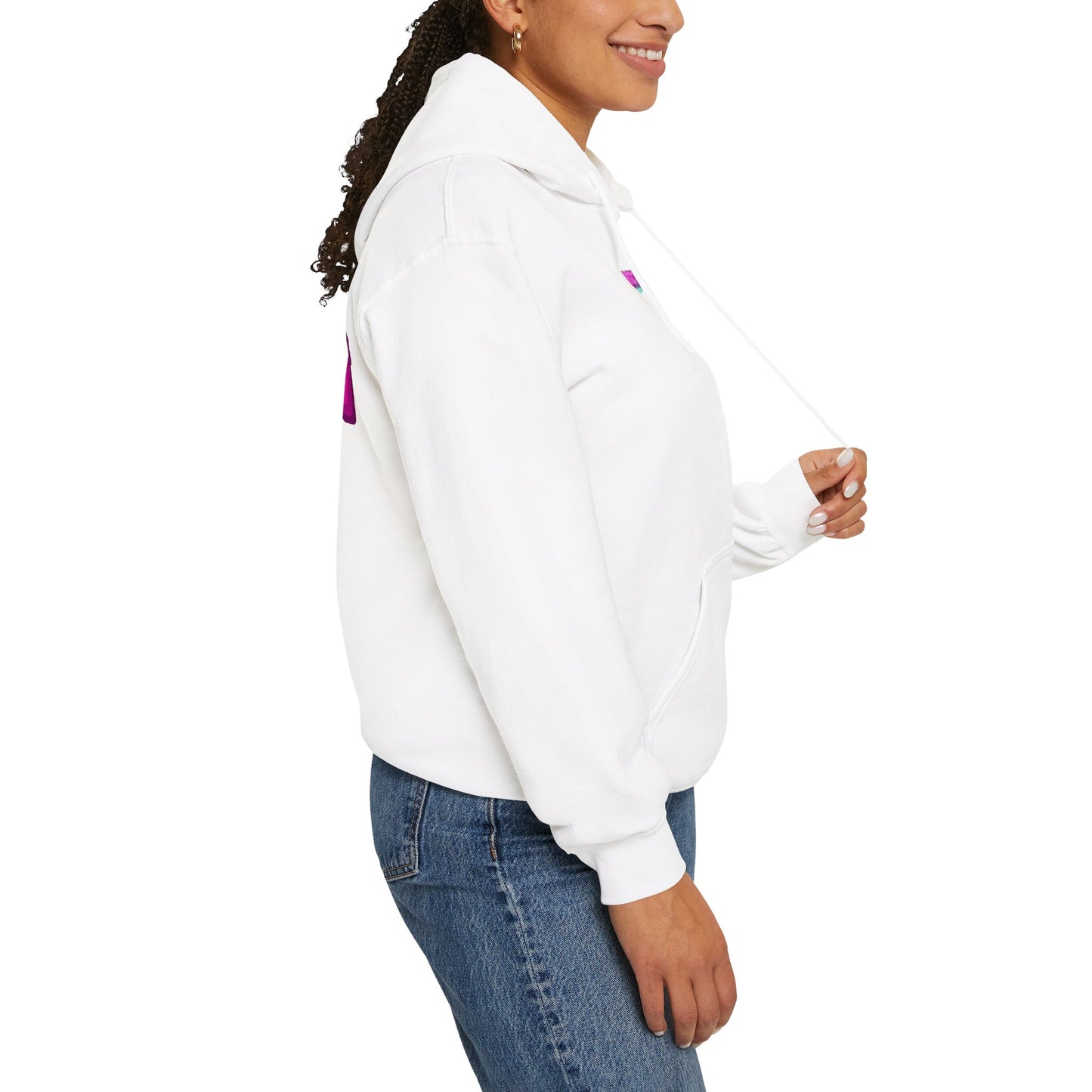 Wearing the Protect Trans Kids Hoodie, a woman in blue jeans is smiling and holding the hoodie strings. She's standing in profile against a white background.