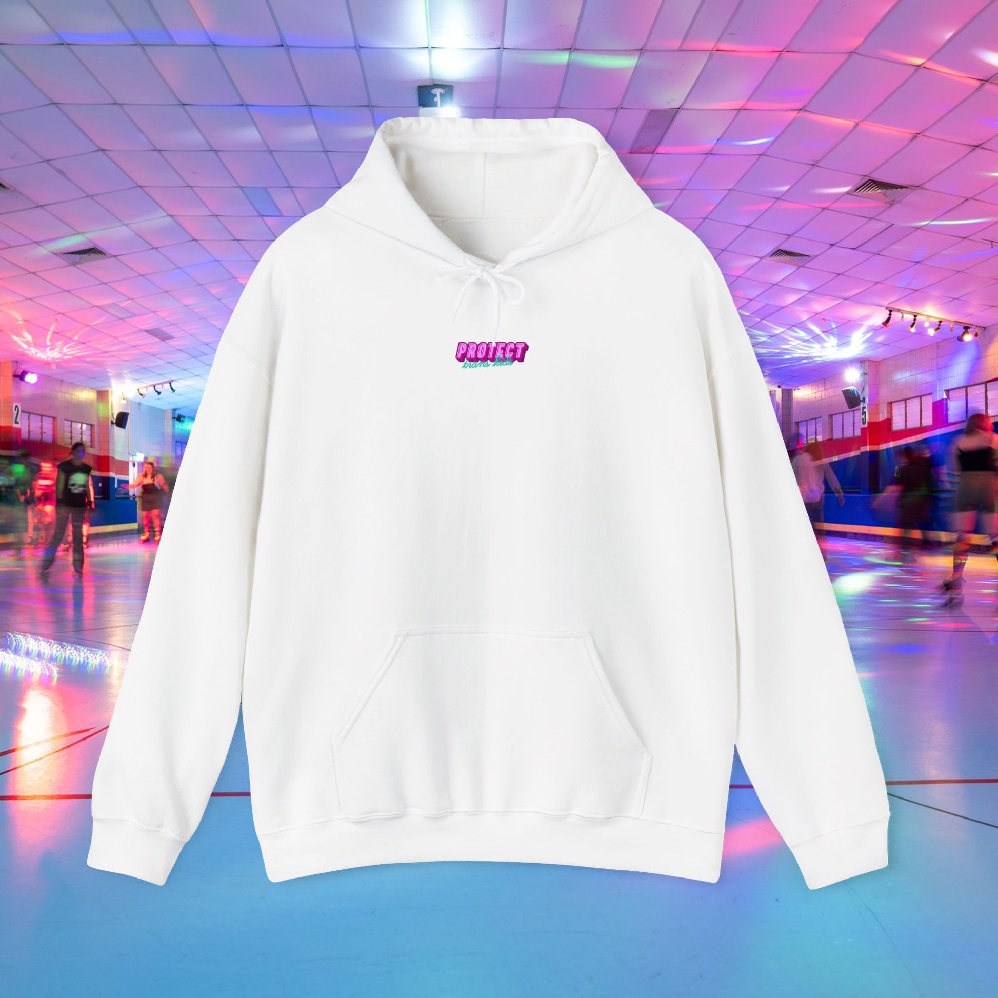 The "Protect Trans Kids Hoodie - Australian Shipping" is a white unisex hoodie with "PROTECT" in pink that hangs against a vibrant roller skating rink, full of neon lights and skaters. Made from ethically grown cotton, it perfectly matches the rink's futuristic vibe with its tiled ceiling and reflective floor.