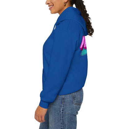 A person in the Protect Trans Kids Hoodie - Australian Shipping stands smiling in profile. The blue unisex heavy blend sweatshirt with pink text on the back highlights their long, curly hair, paired with jeans. The plain white background emphasizes the vibrant hue of ethically grown cotton.