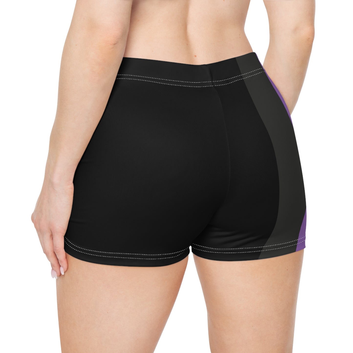 A person is modeling the Non-Binary Pride Flag Short Shorts by Printify, featuring high-waisted custom stripes in black, purple, white, and yellow. Made from moisture-wicking fabric that includes polyester and spandex, the shorts are displayed from the lower torso to the upper thigh.