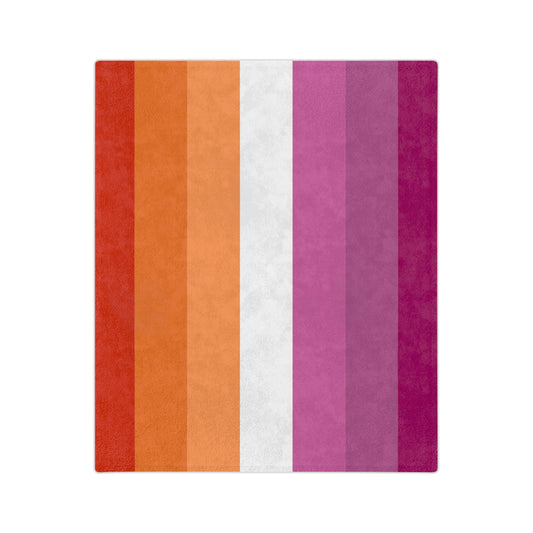 The Lesbian Pride Flag - Velveteen Microfiber Blanket by Printify features a design with seven vertical stripes in shades of dark orange, orange, light orange, white, pink, dusty pink, and dark pink. This super-soft fleece blanket is available in multiple sizes and is crafted by a trans and queer-owned company.