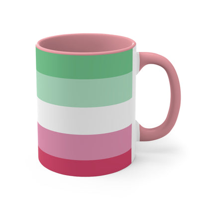 The Abro, Abroromantic, Abrosexual pride flag Accent Mug by Printify is a ceramic mug designed with horizontal stripes in green, light green, white, pink, and red to reflect the vibrant hues of the Abrosexual pride flag. It also features a pink handle and a colorful interior.