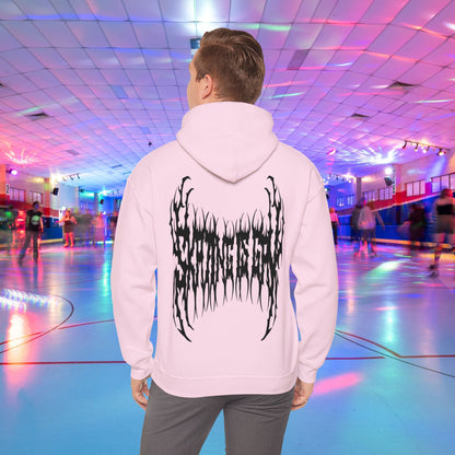 A person wearing the "SKATING IS GAY but make it death metal" hoodie stands in a brightly lit roller skating rink. The rink is adorned with colorful lights, and other people are skating in the background.