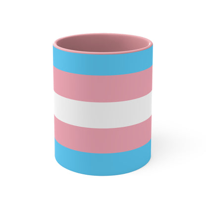 The Trans Pride Flag Colourful Accent Mug by Printify features a ceramic design with horizontal stripes in blue, pink, and white. Its solid blue handle perfectly complements the colorful interior.