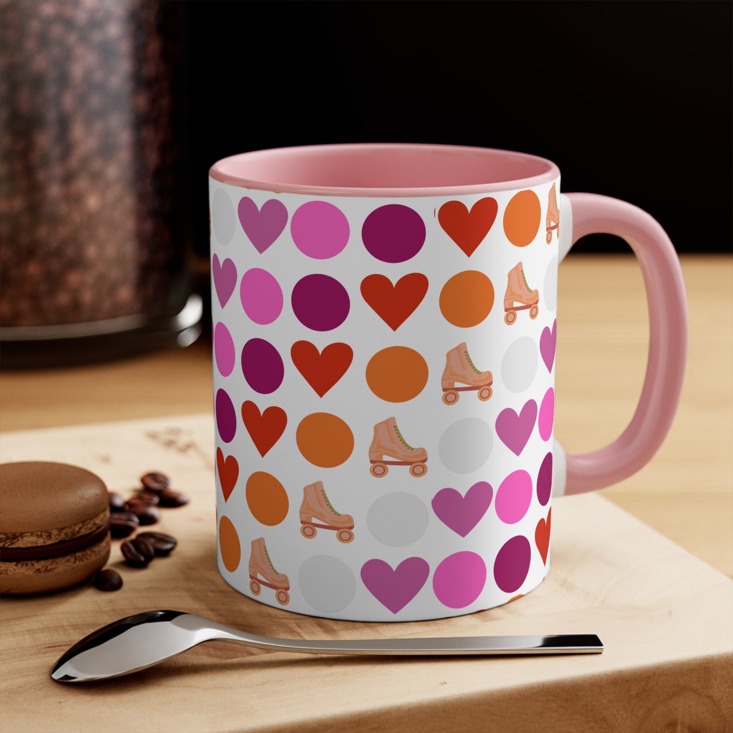 The Subtle Lesbian Pride + Roller Skate Colourful Accent Mug by Printify is a white ceramic mug featuring a red handle and a vibrant interior. It is adorned with a playful pattern of hearts, circles, and roller skates in an array of colors, including pink, purple, orange, and red.