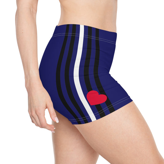 A person is wearing the Leather Pride Flag Short Shorts, featuring a blue base with black vertical stripes and a white stripe. A red heart design adorns the front side of these trans and queer-owned active wear shorts representing the leather pride bdsm flag. or the leather pride, BDSM, kinky, kink, bear community.