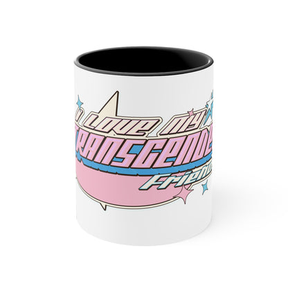 The "I Love My Transgender Friends original design accent mug" by Printify is a white ceramic mug with a black interior, showcasing an eye-catching exterior. Adorned with playful text in pastel pink, blue, and cream that reads "I love my transgender friends," the design is accented by small stars.