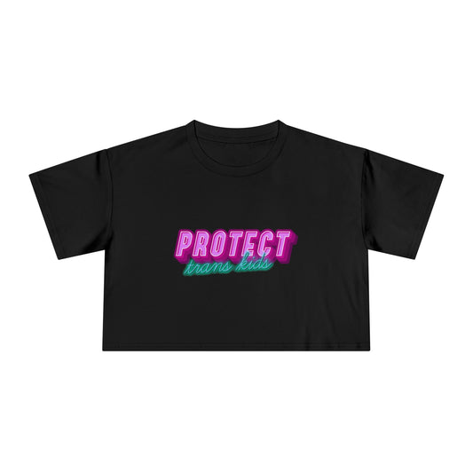 The Gay Skate's "Protect Trans Kids - original design - locally printed crop tee" is a black crop top t-shirt that proudly displays the text "PROTECT trans kids" in bold, vibrant pink and teal letters across the chest. The eye-catching font and incorporation of transgender pride flag colors make it a standout piece in queer skate and streetwear.