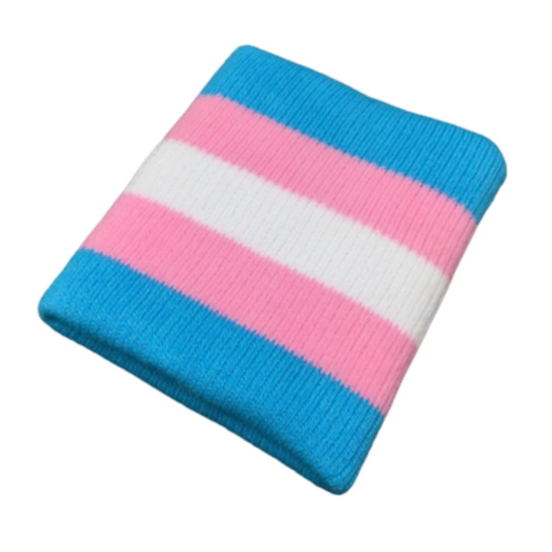 A wrist adorned with the Gay Skate Trans pride flag sporty wrist band featuring horizontal stripes in light blue, pink, and white - the transgender pride flag. An accessory for clubbing, raves, parties and festivals. Perfect for transmen, transgirls, transwomen, non-binary and other genderqueer people.