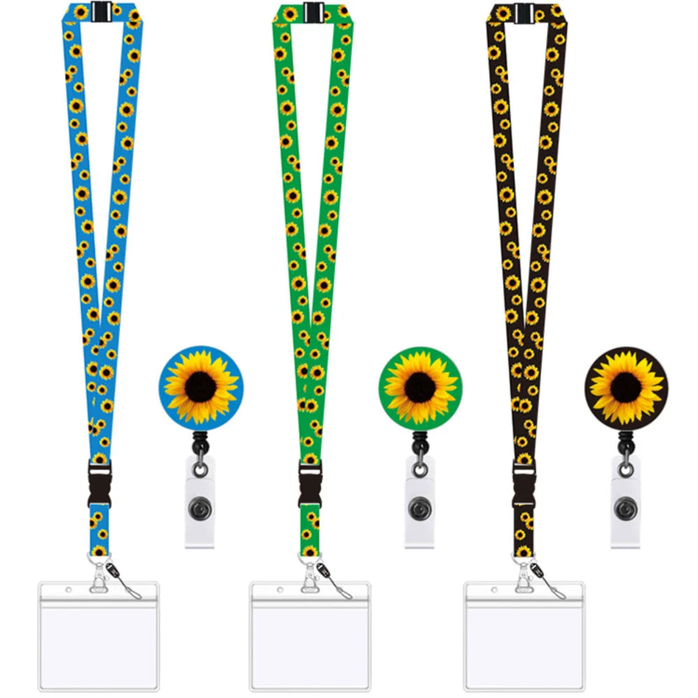 Three Invisible Disability sunflower-patterned retractable badge reel lanyards shown. The lanyards come in blue, green, and black with yellow sunflower prints, and the reels have matching sunflower designs.