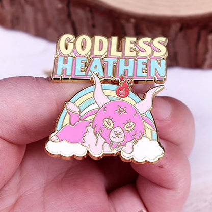 Rainbow, pink and gold enamel Pin with 'Godless Heathen' text and devil creature