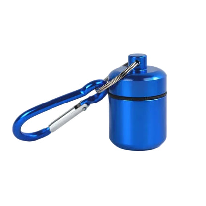 A small cylindrical blue metal mini pill storage container with a screw-top lid and a blue carabiner clip attached