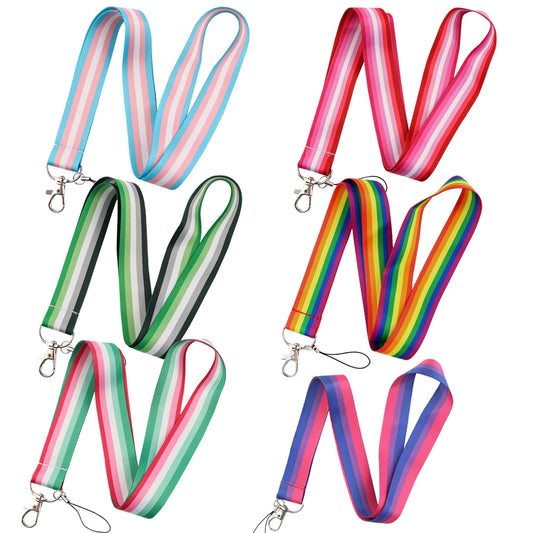 Image of six colorful lanyards arranged in two columns, each featuring a durable metal clasp. The designs include pastel stripes, red stripes, green stripes, blue stripes, pink and blue mix stripes, and vivid rainbow stripes reminiscent of the Pride Flag Lanyard. Perfect LGBTQ+ accessories for identity display from Gay Skate's Pride Flag Lanyard collection—celebrating Rainbow, Trans, Non-Binary, Lesbian, Bisexual, Abrosexual/Abroromantic, and Aromantic pride.