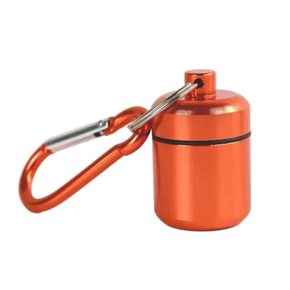A small metallic orange cylindrical medication container and an orange carabiner
