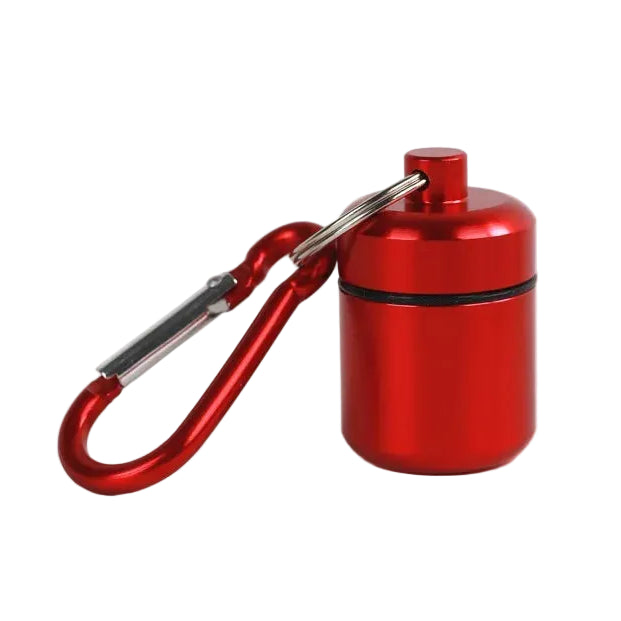 A small metallic red cylindrical container with a matching red screw-top lid, attached to a red carabiner clip