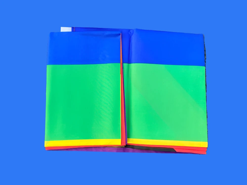 This image showcases the 150cm x 90cm Progress Pride Rainbow Flag by Gay Skate. It is made of high-quality polyester and features traditional rainbow stripes, along with a chevron on the left that includes black and brown stripes, plus light blue, white, and pink stripes to represent marginalized LGBTQ+ communities, including people of color and the trans community.