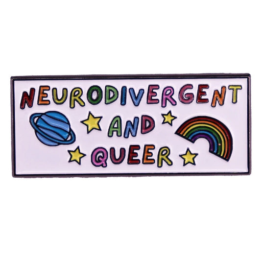 The "Neurodivergent and Queer" enamel pin from Gay Skate is a rectangular badge featuring a white background with a black border. The text "NEURODIVERGENT AND QUEER" is presented in rainbow, handwritten-style letters. This neuroqueer pin is adorned with a blue planet with rings, five yellow stars, and a rainbow.