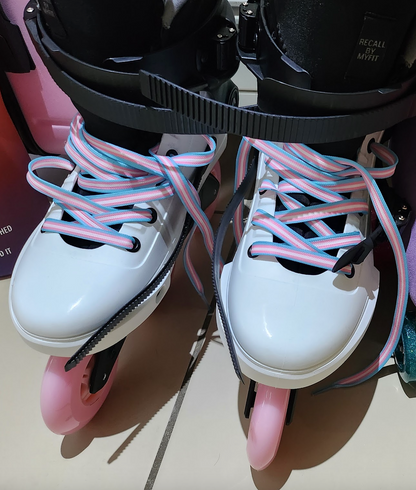 Three pairs of colorful shoelaces are displayed. The first pair is yellow with black and purple stripes, the second pair features a Pride flag pattern, and the third pair is pale pink with teal and coral stripes. All shoelaces are Waxed Skate Laces by Derby Laces, proudly presented under the Gay Skate brand.