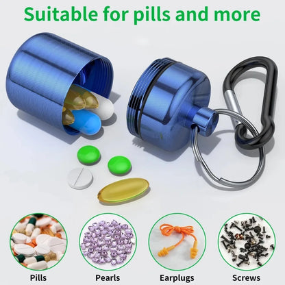A blue metallic pill organizer keychain shown open with capsules and tablets spilled out, alongside a black carabiner clip and ring. Text at the top reads 'Suitable for pills and more,' and four circular insets at the bottom show examples of items it can hold: pills, pearls, earplugs, and screws.