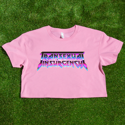 Pink crop top with 'Transsexual Insurgence' text on a grass background